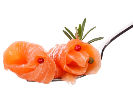 Salmon piece on fork isolated on white background cutoutの写真素材