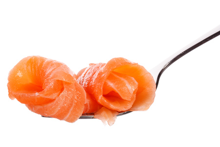 Salmon piece on fork isolated on white background cutoutの写真素材