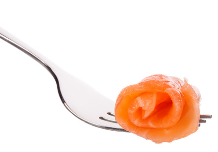 Salmon piece on fork isolated on white background cutoutの写真素材