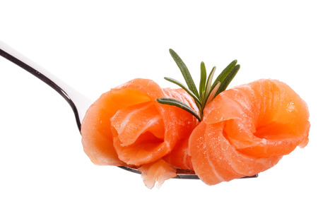 Salmon piece on fork isolated on white backgroundの写真素材