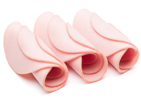 cooked boiled ham sausage or rolled bologna slices isolated on white background cutoutの写真素材