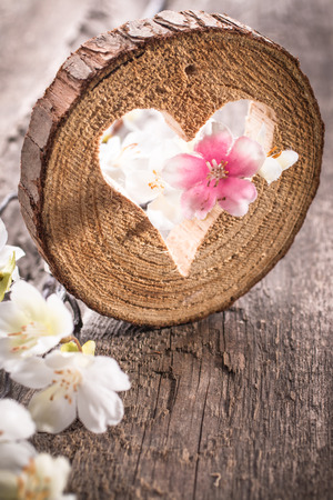 Wooden heart hole on rustic wooden backgroundの写真素材