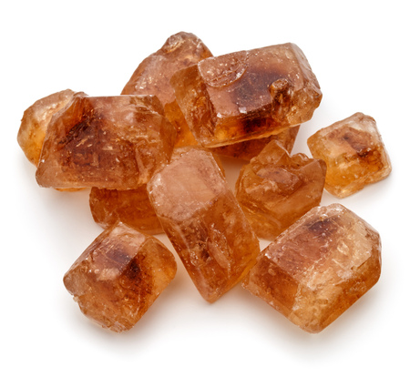 Brown caramelized lump cane sugar cube isolated on white background cutoutの写真素材