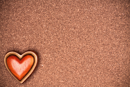 One wooden heart on rustic wood background. Valentines days concept.  Love symbol. Greeting card with copy space.の写真素材