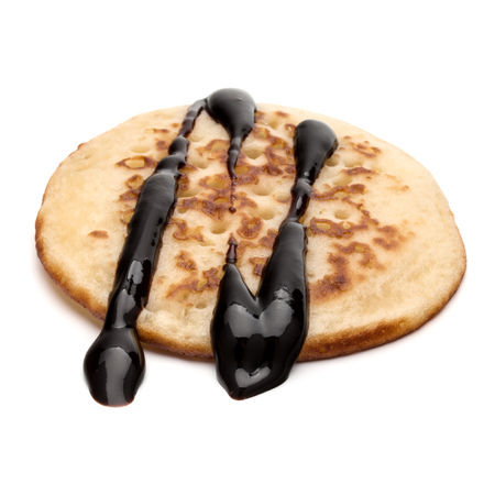One pancake with chocolate syrup isolated on white background cutout.の写真素材