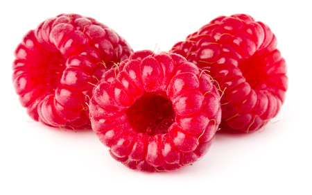 three ripe raspberries isolated on white background close up