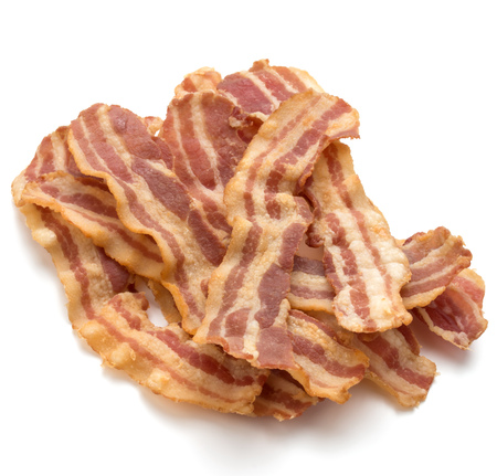 cooked crispy slices of bacon isolated on white backgroundの写真素材