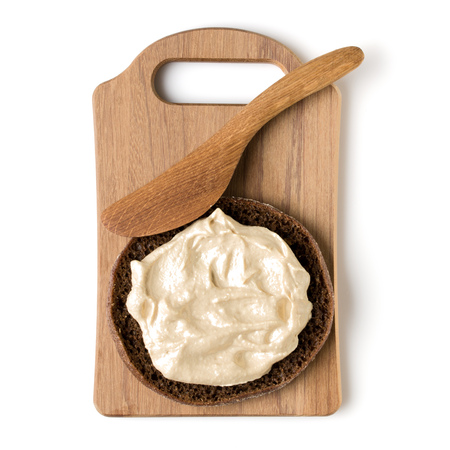 Open  faced hummus sandwich canape or crostini on a wooden serving board  isolated on white background closeup. Top view. Vegetarian tartarine.の写真素材