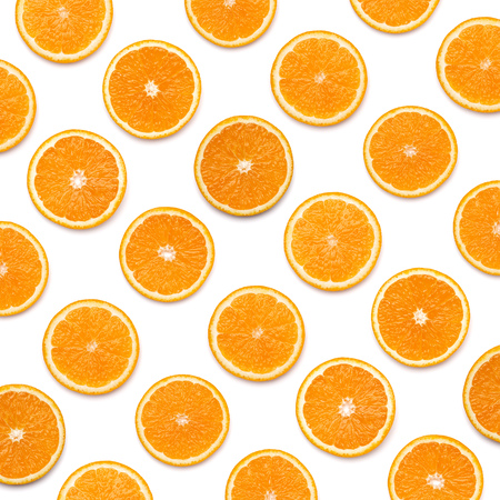 pattern of orange fruit slices. Orange slices isolated on white background. Food background. Flat lay, top view.の写真素材