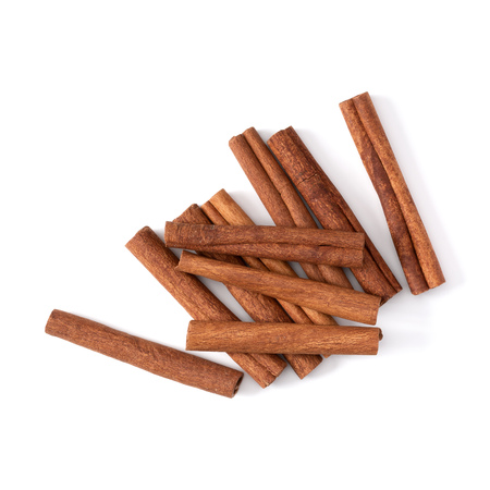 Cinnamon sticks isolated on white background closeup. Canella spice. Aromatic condiment background. Flat lay, top view.の写真素材