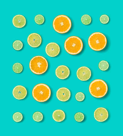 Citrus Fruit pattern on blue background. Orange, Lime, Lemon slices background. Flat lay, top view.の写真素材