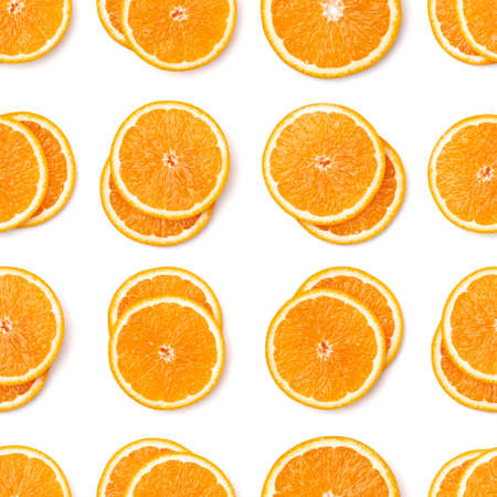 Seamless pattern of orange fruit slices. Orange slices isolated on white background. Food background. Flat lay, top view.の写真素材