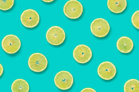 Fruit pattern of lemon slices on blue background. Flat lay, top view.. Pop art design, creative summer concept.の写真素材