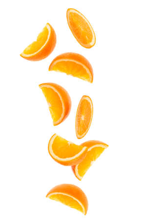 falling fresh orange fruit slices isolated on white background closeup. Flying food concept.の写真素材