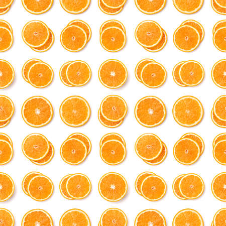 Seamless pattern of orange fruit slices. Orange slices isolated on white background. Food background. Flat lay, top view.の写真素材