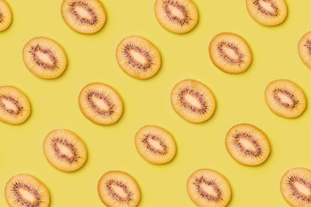 Kiwi slices pattern on green background. Food background. Fruit pattern.  Pop art design, creative summer concept.の写真素材