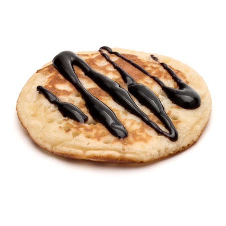 One pancake with chocolate syrup isolated on white background cutout.の写真素材