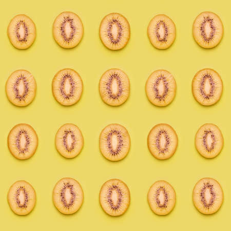 Kiwi slices pattern on green background. Food background. Fruit pattern.  Pop art design, creative summer concept.の写真素材