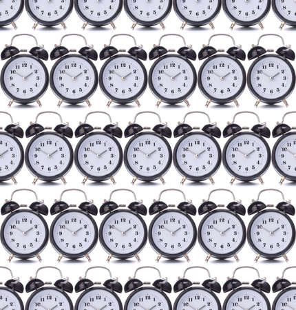 Black alarm clock isolated on white background. Seamless pattern.の写真素材