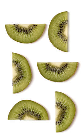 Creative layout made of kiwi slices. Flat lay, top view. Vegetables isolated on white background. Food ingredient pattern...の写真素材