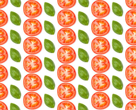 Creative layout made of tomato slices. Flat lay, top view. Vegetables isolated on white background. Food ingredient seamless pattern..の写真素材
