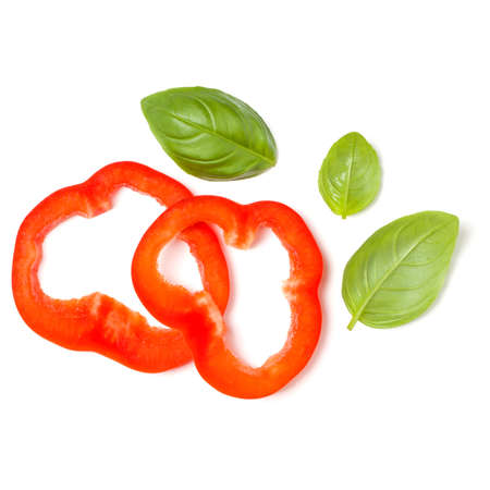 red pepper slices with basil leaves isolated over white background cutout. Top view, flat lay.の写真素材