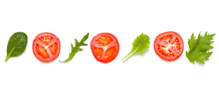 Creative layout made of tomato slices and lettuce salad leaves. Flat lay, top view. Food concept....