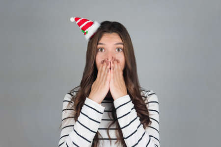 Christmas woman. Girl posing surprise. Portrait, close-up. High quality photoの写真素材