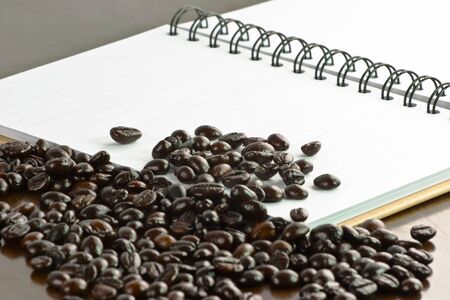 Coffee grain on notebook,table floorの写真素材