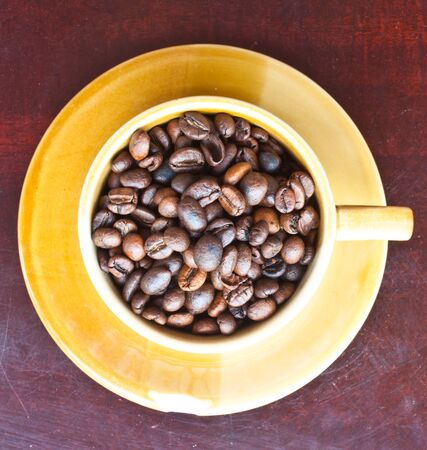 beans coffee on brown cup,top viewの写真素材
