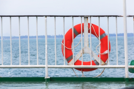 life preserver and rope hanging on old wooden boat の写真素材