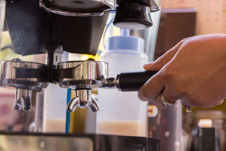 bean coffee and stainless spoon on coffee machine