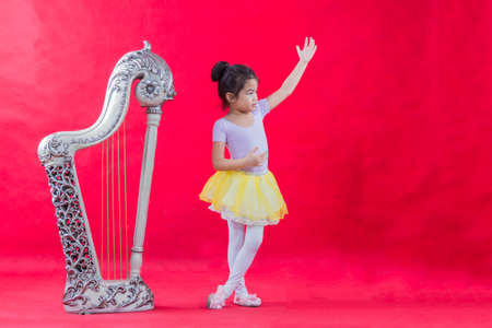 Girl ballet dancer on red backgroundのeditorial素材