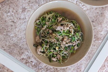 delicious young sunflower fried in brown dishの写真素材