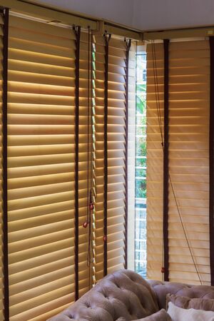 brown wood curtain close mirror window with sofaの写真素材