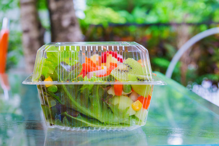 fresh vegetable and fruit in plastic ware on mirror tableの写真素材