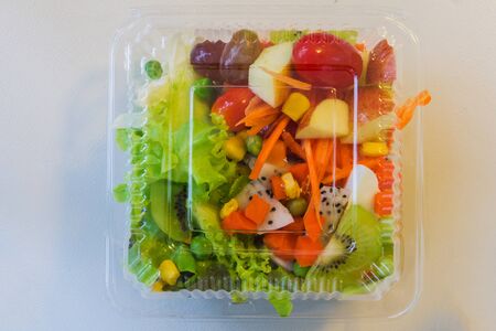 fresh vegetable and fruit in plastic ware on mirror tableの写真素材