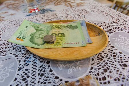 banknote thai in wooden tray on table
