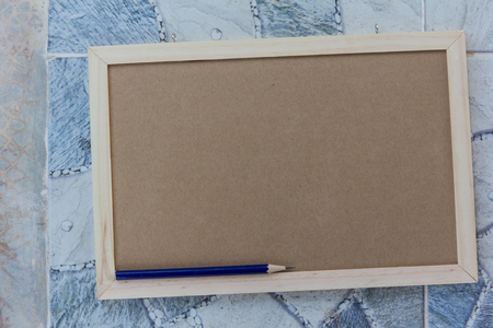 brown wood frame background with blue pencilの写真素材