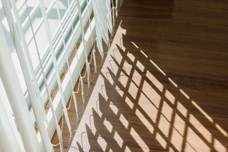 shadow lighting through white curtain on wood floorの写真素材