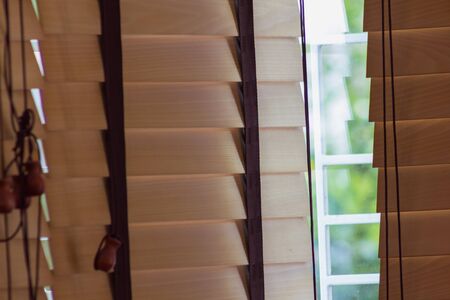 brown wood curtain control lighting at window with light leakの写真素材