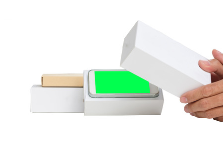 hand holding smart phone box after unpacking with green monitorの写真素材
