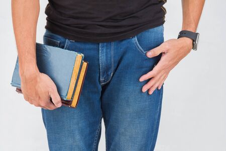 man holding book using right hand isolated with gray backgroundの写真素材