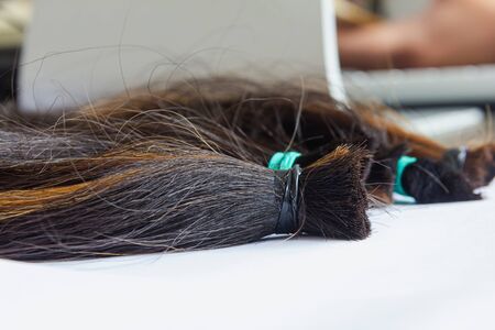 hair tied together for do wig on with background, donated to people with cancerの写真素材