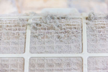 close up on air conditioner filter is very dirty after remove from unit wait cleaningの写真素材