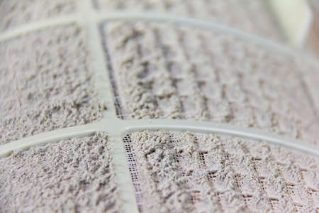 close up on air conditioner filter is very dirty after remove from unit wait cleaning