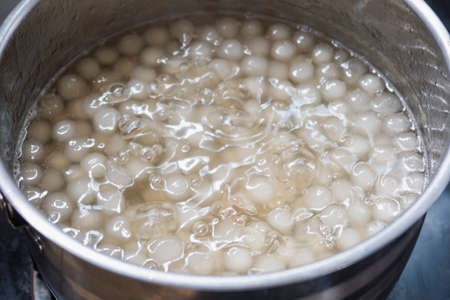 thai dessert call Palm ball Syrup on big spoon make from corypha umbraculifera ball in kitchenの写真素材