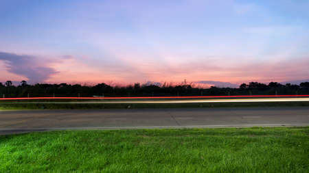 street lights stretch in the evening against tree Silhouette background and the sunset timeの写真素材