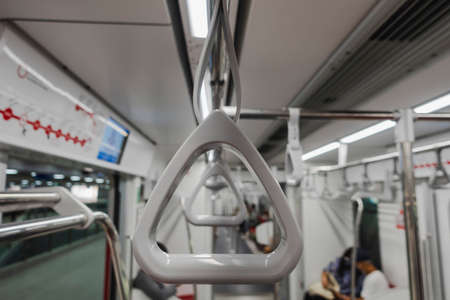 Safety loops on electric trains for passengers hold when stand at dayの写真素材