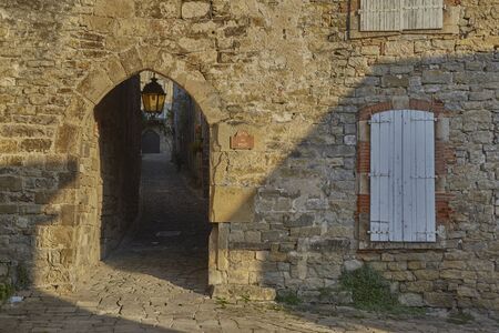 Shadows on the walls of an old house in Porte Du Pont square of medieval little town of Penne, in...